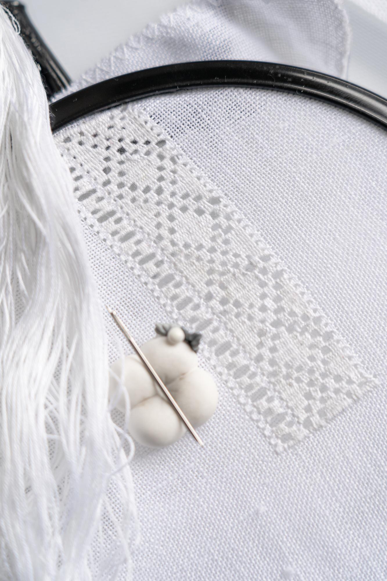 Delicate embroidered boutonniere in pastel threads
